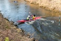 GRODNO, BELARUS - APRIL, 2019: kayak freestyle competition on fast cold water river strenuously rowing, spirit of victory