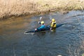 GRODNO, BELARUS - APRIL, 2019: kayak freestyle competition on fast cold water river strenuously rowing, spirit of victory