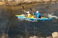 GRODNO, BELARUS - APRIL, 2019: kayak freestyle competition on fast cold water river strenuously rowing, spirit of victory