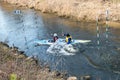 GRODNO, BELARUS - APRIL, 2019: kayak freestyle competition on fast cold water river strenuously rowing, spirit of victory