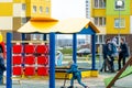 Grodno, Belarus April 1, 2023: Modern outdoor playground in the courtyard of the house. Children and teenagers play on swings and