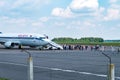 GRODNO, BELARUS - AUGUST 2019: crowd of tourists near the plane awaiting flight. Aircraft that await passengers Royalty Free Stock Photo