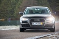 GRODNO, BELARUS - DECEMBER 2019: Audi A6 4G, C7 2016 black metallic front view headlights on outdoors on winter empty