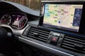GRODNO, BELARUS - DECEMBER 2019: Audi A6 4G C7 interior in dark tones with display with GPS navigation map multimedia