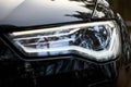 GRODNO, BELARUS - DECEMBER 2019: Audi A6 4G C7 Luxury Black car parts left front BiXenon headlight with luminous led