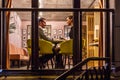 GRODNO, BELARUS - DECEMBER, 2018: loving couple at the table drinking coffee in interior in small modern pub cafe with loft design