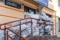 Grodno, Belarus, February 25, 2022: New arrival of clothes in a second-hand store. Old used clothes in large plastic bags.