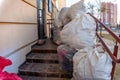 Grodno, Belarus, February 25, 2022: New arrival of clothes in a second-hand store. Old used clothes in large plastic bags. Royalty Free Stock Photo