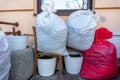 Grodno, Belarus, February 25, 2022: New arrival of clothes in a second-hand store. Old used clothes in large plastic bags.