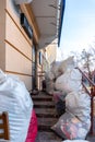 Grodno, Belarus, February 25, 2022: New arrival of clothes in a second-hand store. Old used clothes in large plastic bags.