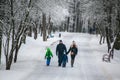 GRODNO, BELARUS - JANUARY 15, 2017. Family, father, mother, daughter and son walking in winter forest