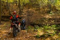 Grodno, BELARUS July 1, 2022: A group of motorcyclists trains in the autumn forest. Trips through the forest on an enduro