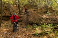 Grodno, BELARUS July 1, 2022: A group of motorcyclists trains in the autumn forest. Trips through the forest on an enduro