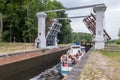 GRODNO, BELARUS - JULY 2021: steamer with a lot of people rises in lock. gateway lock sluice drawbridge construction on river,