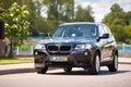 GRODNO, BELARUS - JUNE 2020: BMW X3 II F25 2.0i xDrive front three fourth view outdoors on sunny road background of