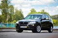 GRODNO, BELARUS - JUNE 2020: BMW X3 II F25 2.0i xDrive front three fourth view outdoors on sunny road background of