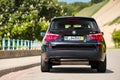 GRODNO, BELARUS - JUNE 2020: BMW X3 II F25 2.0i xDrive selective focus down back view with wheels turned outdoors on Royalty Free Stock Photo