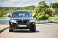 GRODNO, BELARUS - JUNE 2020: BMW X3 II F25 2.0i xDrive selective focus front view with wheels standing straight outdoors Royalty Free Stock Photo