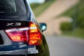 GRODNO, BELARUS - JUNE 2020: BMW X3 II F25 xDrive Black car right rear clear glass led taillight turn on signal Royalty Free Stock Photo