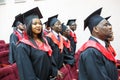 GRODNO, BELARUS - JUNE, 2018: Foreign african medical students in square academic graduation caps and black raincoats during