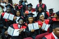 GRODNO, BELARUS - JUNE, 2018: Foreign african medical students in square academic graduation caps and black raincoats during