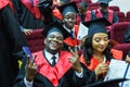 GRODNO, BELARUS - JUNE, 2018: Foreign african medical students in square academic graduation caps and black raincoats during Royalty Free Stock Photo