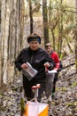 Cute elderly caucasian women wearing sportswear running through a forest