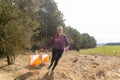 Strong caucasian young woman wearing sportswear running through a forest