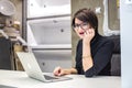 GRODNO, BELARUS - MARCH 2019: young woman employees in glass works at the computer in modern shop Royalty Free Stock Photo