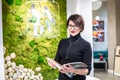 GRODNO, BELARUS - MARCH 2019: young woman employees in glass works at the computer in modern shop Royalty Free Stock Photo