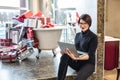 GRODNO, BELARUS - MARCH 2019: young woman employees in glass works at the computer in modern shop with bath of gifts Royalty Free Stock Photo