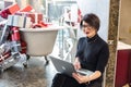 GRODNO, BELARUS - MARCH 2019: young woman employees in glass works at the computer in modern shop with bath of gifts Royalty Free Stock Photo