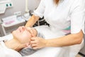 GRODNO, BELARUS - MAY 2018: woman doing facial massage at the beauty salon