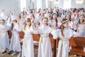 GRODNO, BELARUS - MAY 2019: Young children in the Catholic Church are waiting for the first eucharist communion. Little angels in Royalty Free Stock Photo