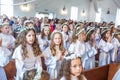 GRODNO, BELARUS - MAY 2019: Young children in the Catholic Church are waiting for the first eucharist communion. Little angels in Royalty Free Stock Photo