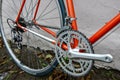 Bicycle repair. Wheel and shiny axle of chrome steel of an old road bike closeup. Retro bike. Red iron fork. Quick Release