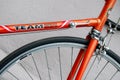 Bicycle repair. Wheel and shiny axle of chrome steel of an old road bike closeup. Retro bike. Red iron fork. Quick Release