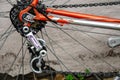 Bicycle repair. Wheel and shiny axle of chrome steel of an old road bike closeup. Retro bike. Red iron fork. Quick Release