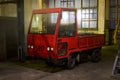 GRODNO, BELARUS - NOVEMBER 2020: Vintage old fashioned style red cargo electric car truck stands into warehouse late at