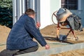 Grodno, Belarus, October 21, 2018: a group of builders engaged in the repair of a Catholic church. Laying a new sidewalk. Chief