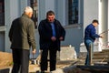 Grodno, Belarus, October 21, 2018: a group of builders engaged in the repair of a Catholic church. Laying a new sidewalk. Chief