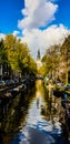 Groenburgwal canal in Amsterdam with the Soutern church Zuiderkerk at sunset in Fall