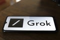 The Grok logo is displayed on the screen of a smartphone, in Reno, United States, on November 12, 2024. Grok is a generative