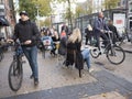 People with bicycle and young people sitting at table of outdoor cafe in groningen