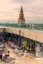 Roof top of Forum Groningen library with tourists in front of the famous Martinitoren church tower in Groningen, The Netherlands