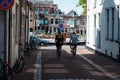Groningen, The Netherlands, Young couple driving through the streets of old town with the bicycle