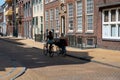 Groningen, The Netherlands, Young student girls driving the bike through the streets of old town