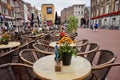 Cafe tables and chairs outdoors in a Dutch shopping square