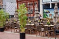 Cafe tables and chairs outdoors in a pedestrian shopping square