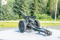 Gronsvik, Norway - August 06, 2019: Back left view at artilery gun standing in front of Main building of museum of Gronsvik